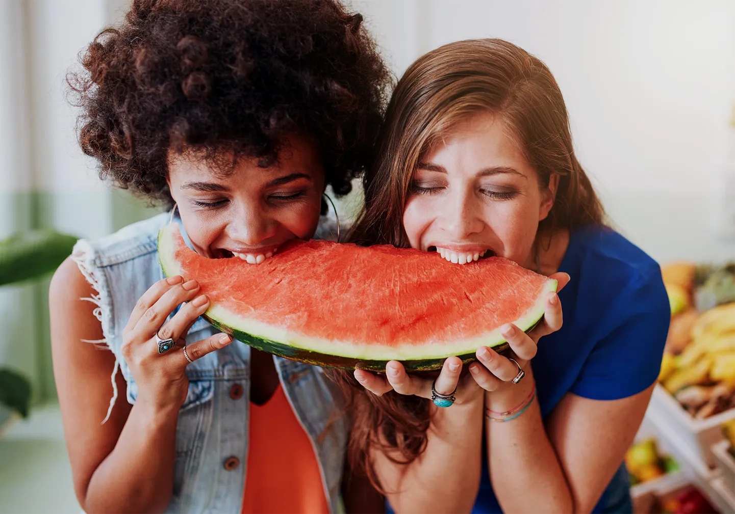 Two friends sharing a huge slice of ripe watermelon